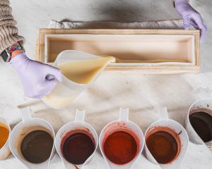 Fall-colored soaps split into containers and ready to pour